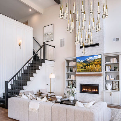 Modern living room with staircase, white sofa, and decorative lighting.